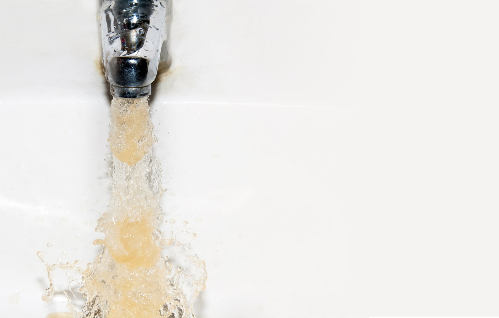Glass of tap water being filled, emphasizing need for filtration