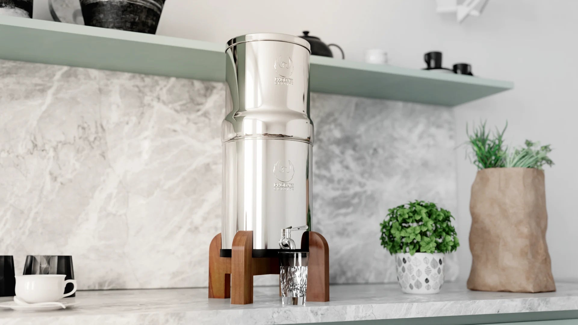 Stainless steel coffee maker on a kitchen counter with a plant and cups in the background